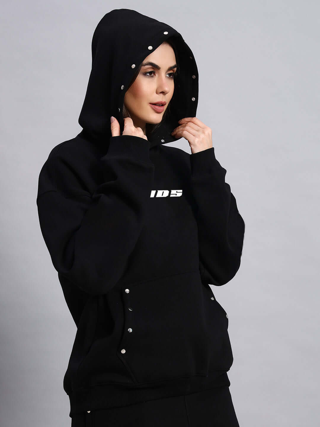 Model wearing DUDS Women Rigid Fleece Hoodie in black, featuring customizable fit by experienced tailors. Made-to-order with 7-10 day dispatch.