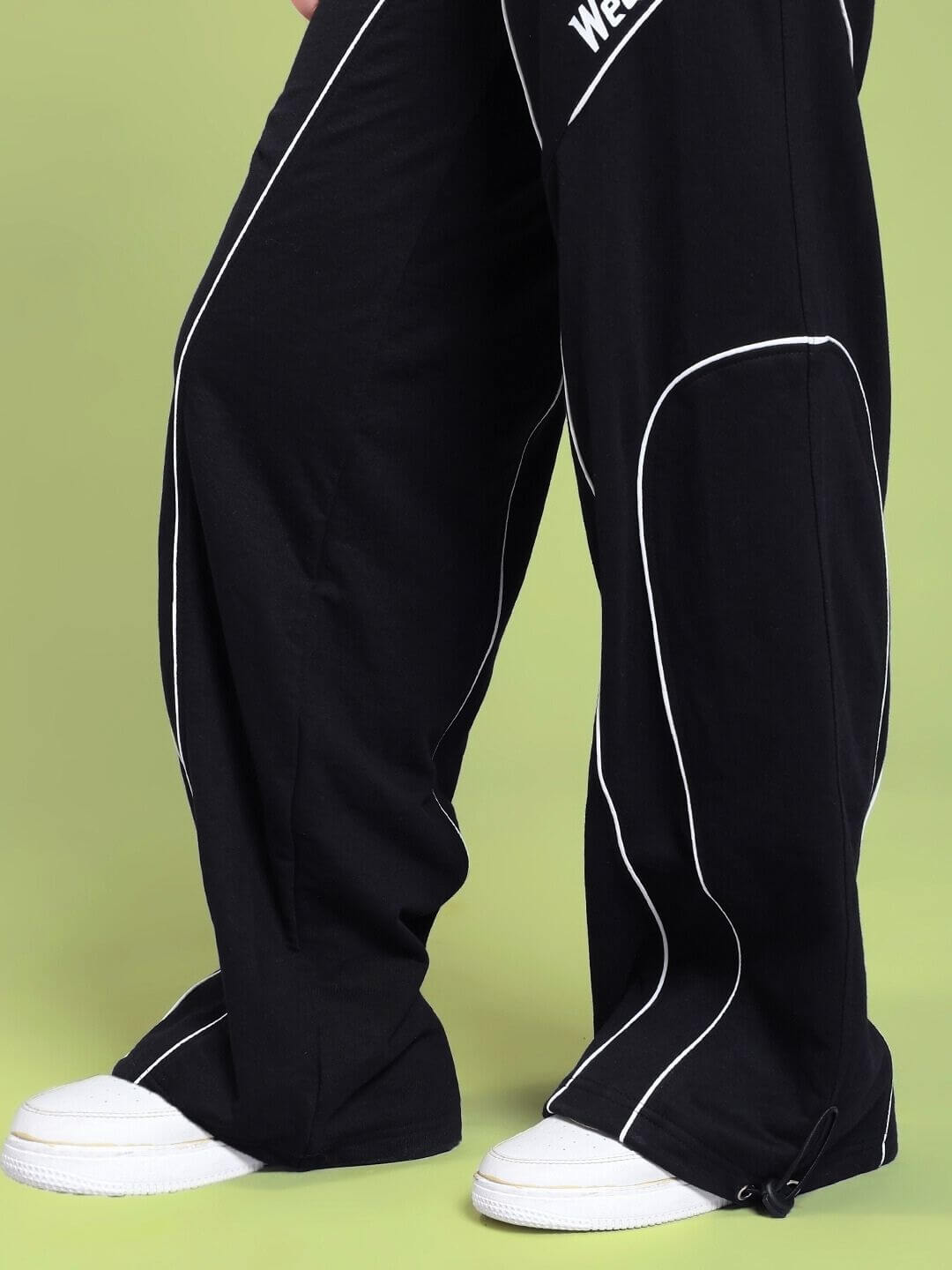Close-up of WOMEN SIGNATURE PIPING JOGGERS BLACK with contrast piping and relaxed fit, showcasing style and comfort.