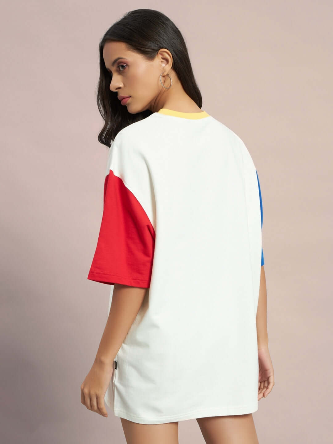 Rear view of model wearing Women's Adonis oversized color blocked T-shirt in off white with red and blue sleeves, made from premium cotton.