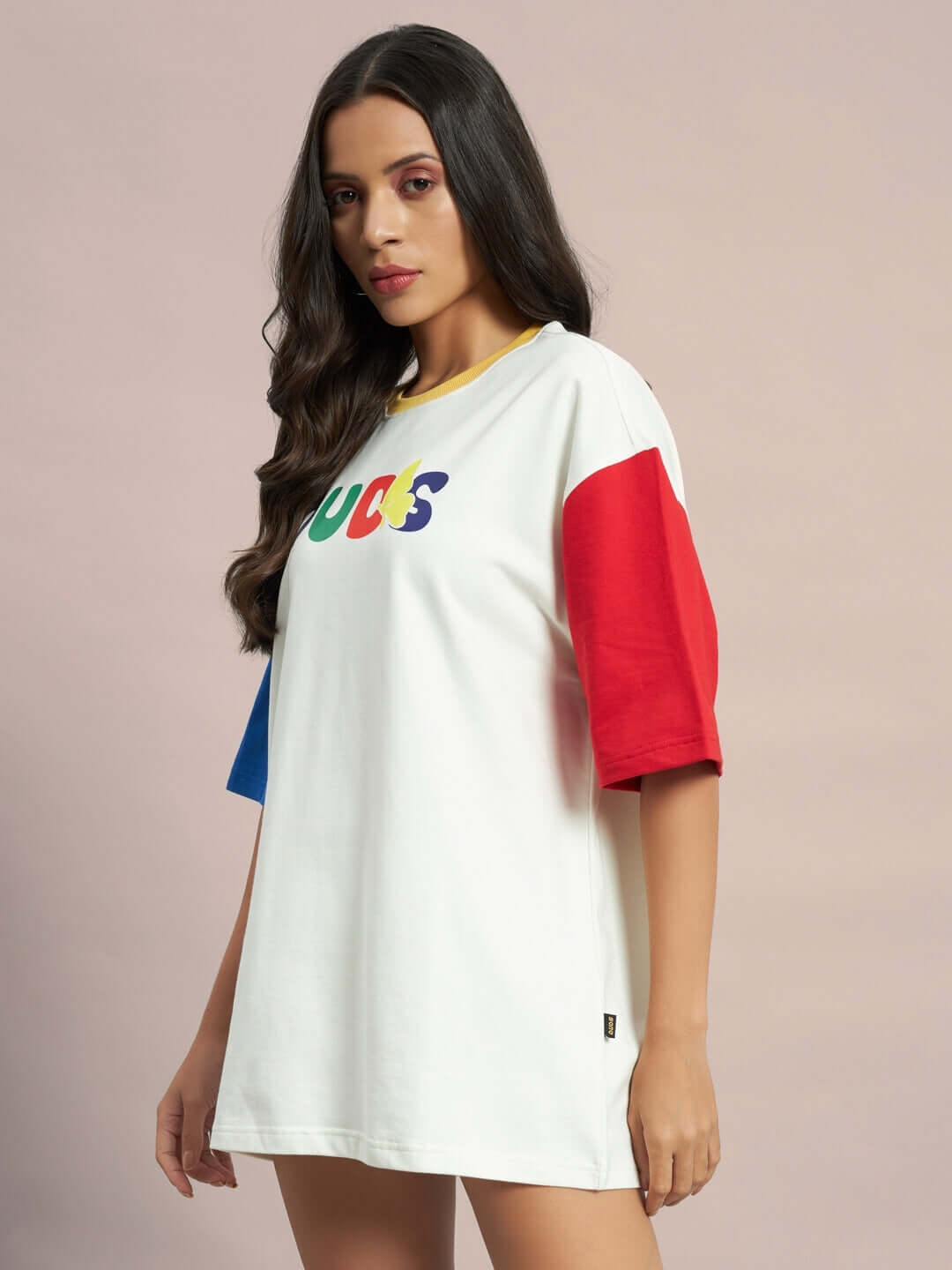 Model wearing women's Adonis oversized color-blocked t-shirt in off white, featuring red and blue sleeves, made from premium cotton fabric.