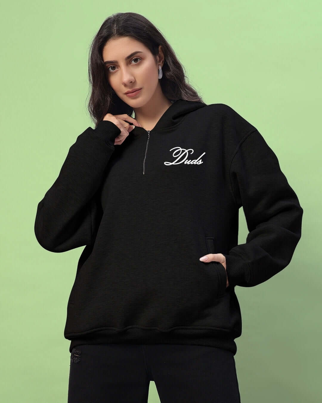 Woman wearing black Amarillo fleece hoodie from Duds, featuring zip and logo, front view