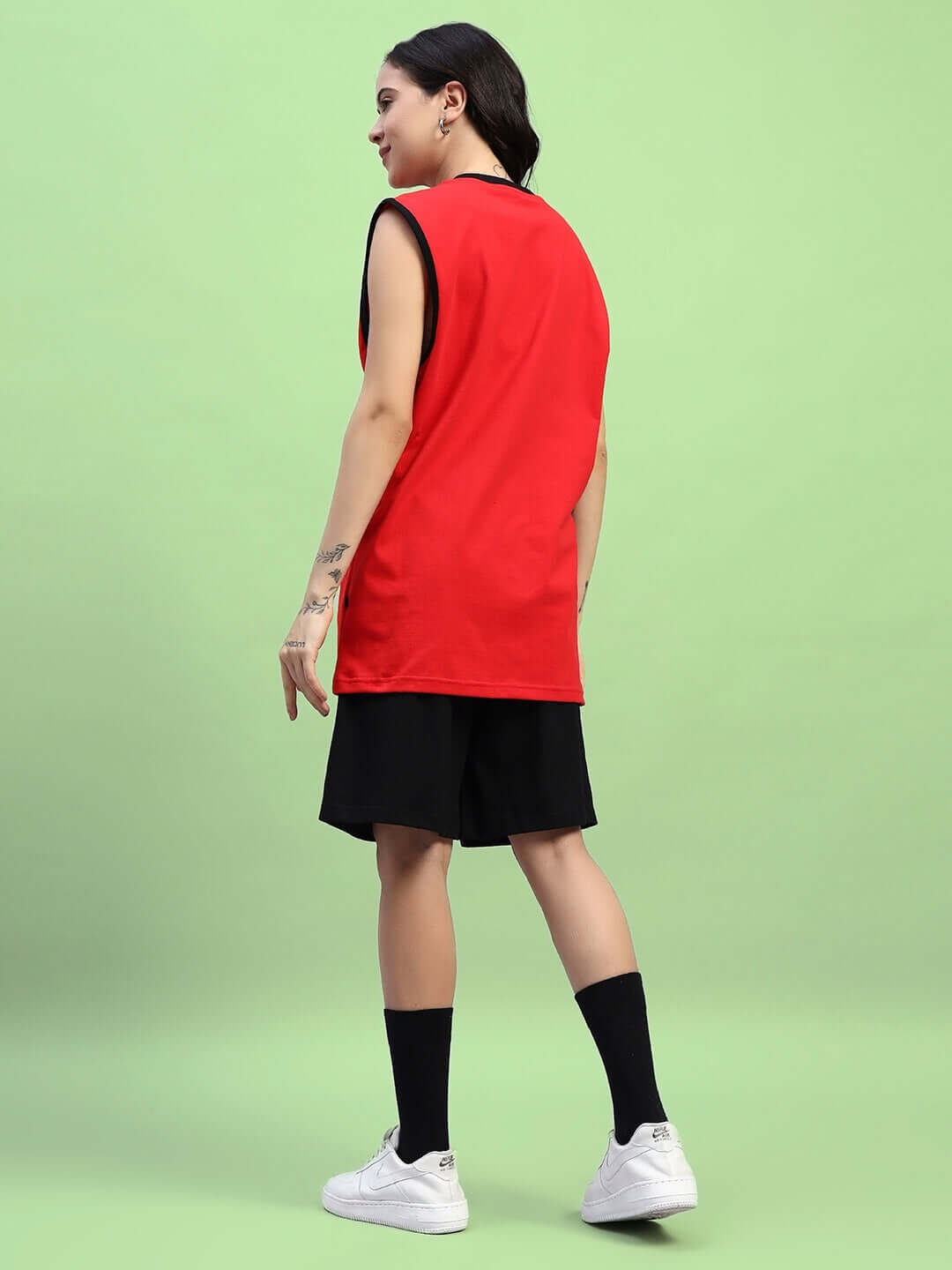 Woman wearing WOMEN'S AMIGA GYM CO-ORD SET RED-BLACK, 100% cotton, sportswear on a green background.