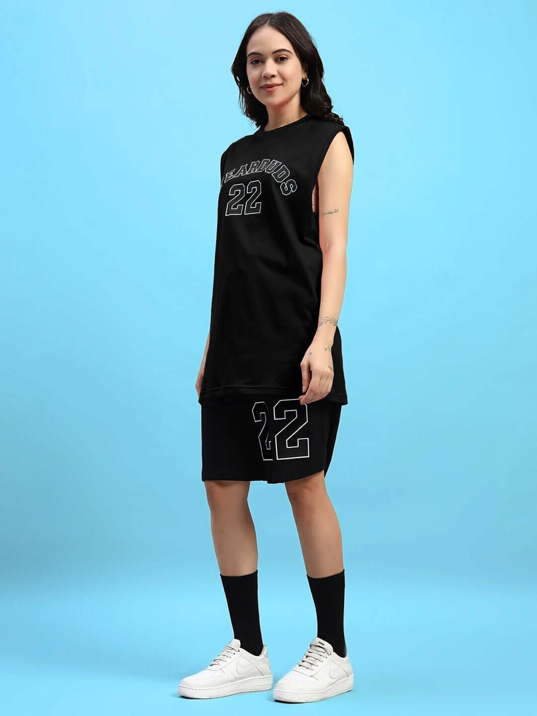 Woman wearing black AMIGA gym co-ord set, comfortable cotton material, ideal for workouts. Showcasing sporty style, perfect for active wear.