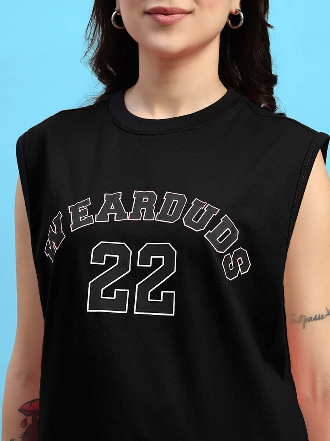 Close-up of a woman wearing a black DUDS gym T-shirt with 'WEARDUDS 22' printed on the front, featuring a sleeveless design.