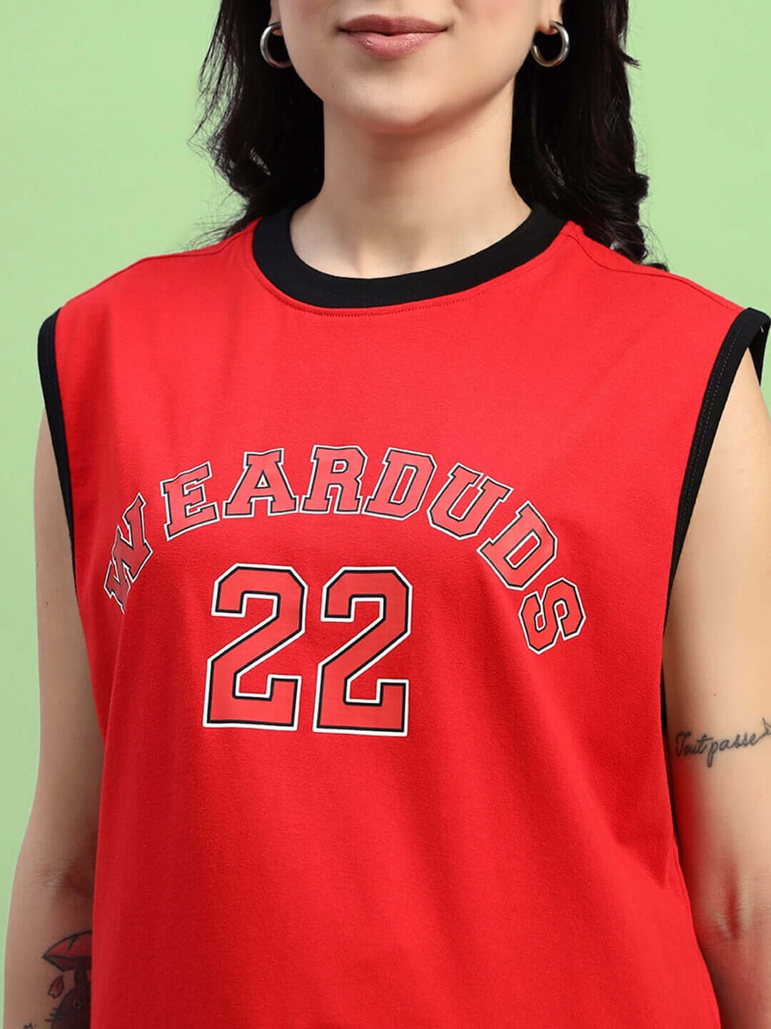 Woman wearing red sleeveless top with number 22 and 'WEARDUDS' text.