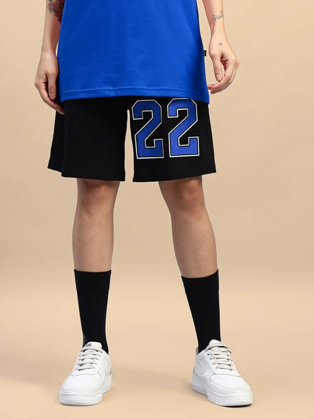 Model wearing WOMEN'S AMIGA Regular Fit Shorts in black-blue with '22' design, customizable size option available, ideal for casual wear.