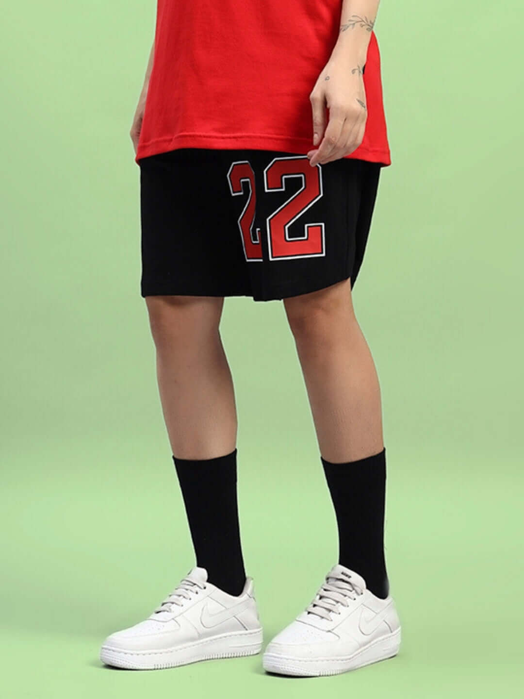 WOMEN'S AMIGA REGULAR FIT SHORTS BLACK RED sporty shorts with red accents and number 22 detail, styled with a sporty red top and sneakers.