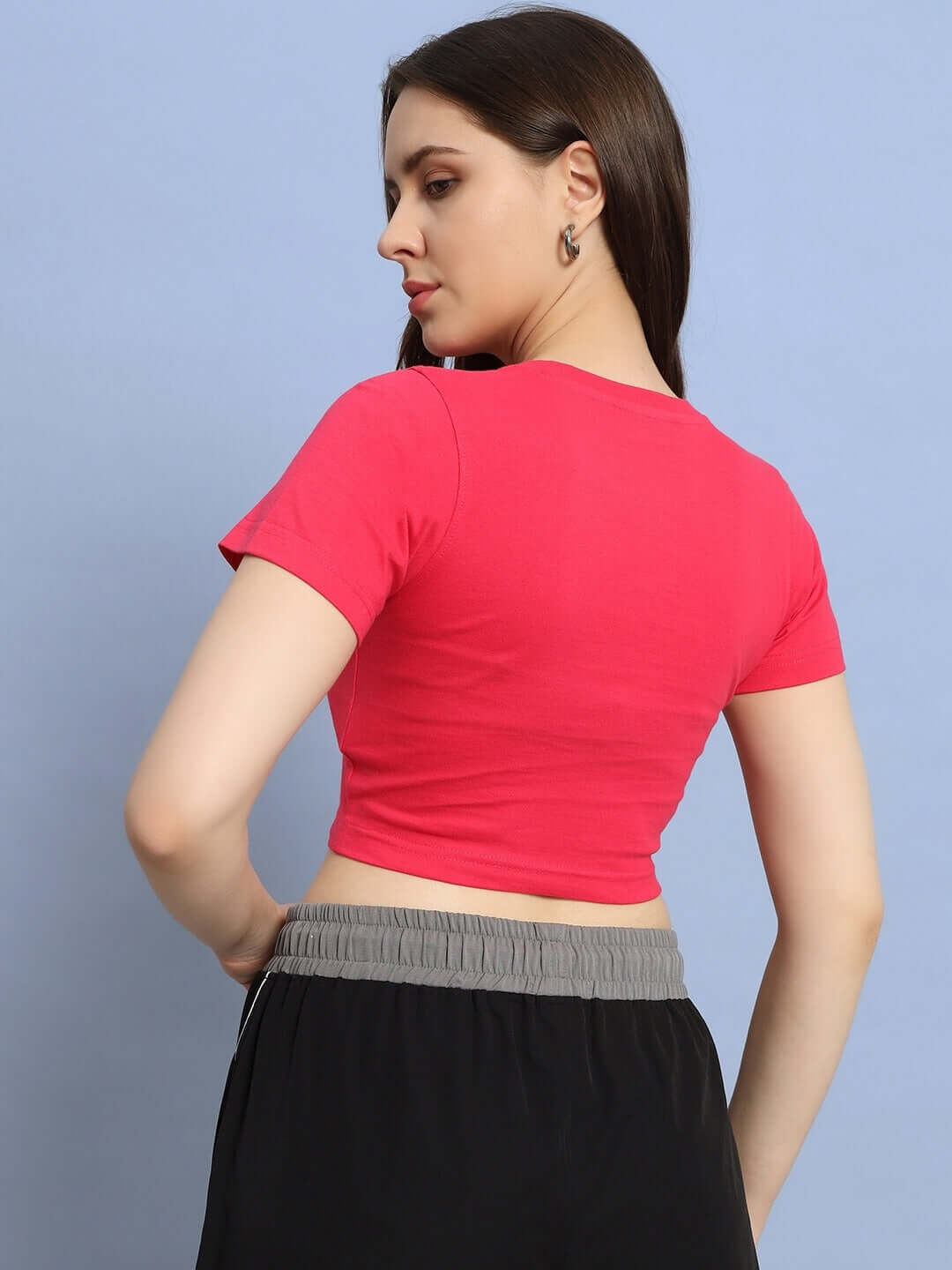 Back view of model wearing Women Amore Women Crop-Top Pink, showcasing vibrant color and flattering fit. Perfect for casual wear.