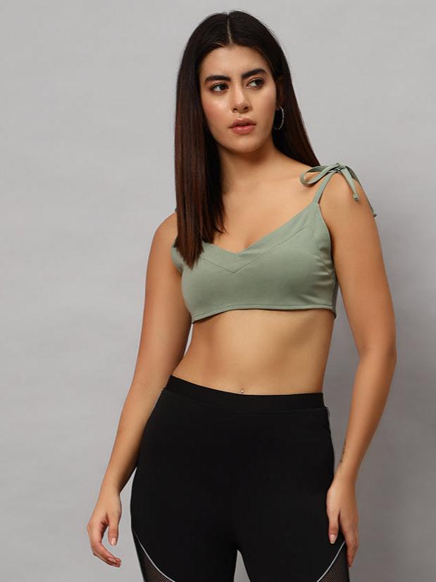 Woman wearing WOMEN ASHLEY CROP-TOP LAUREL GREEN showcasing flattering crop design style.