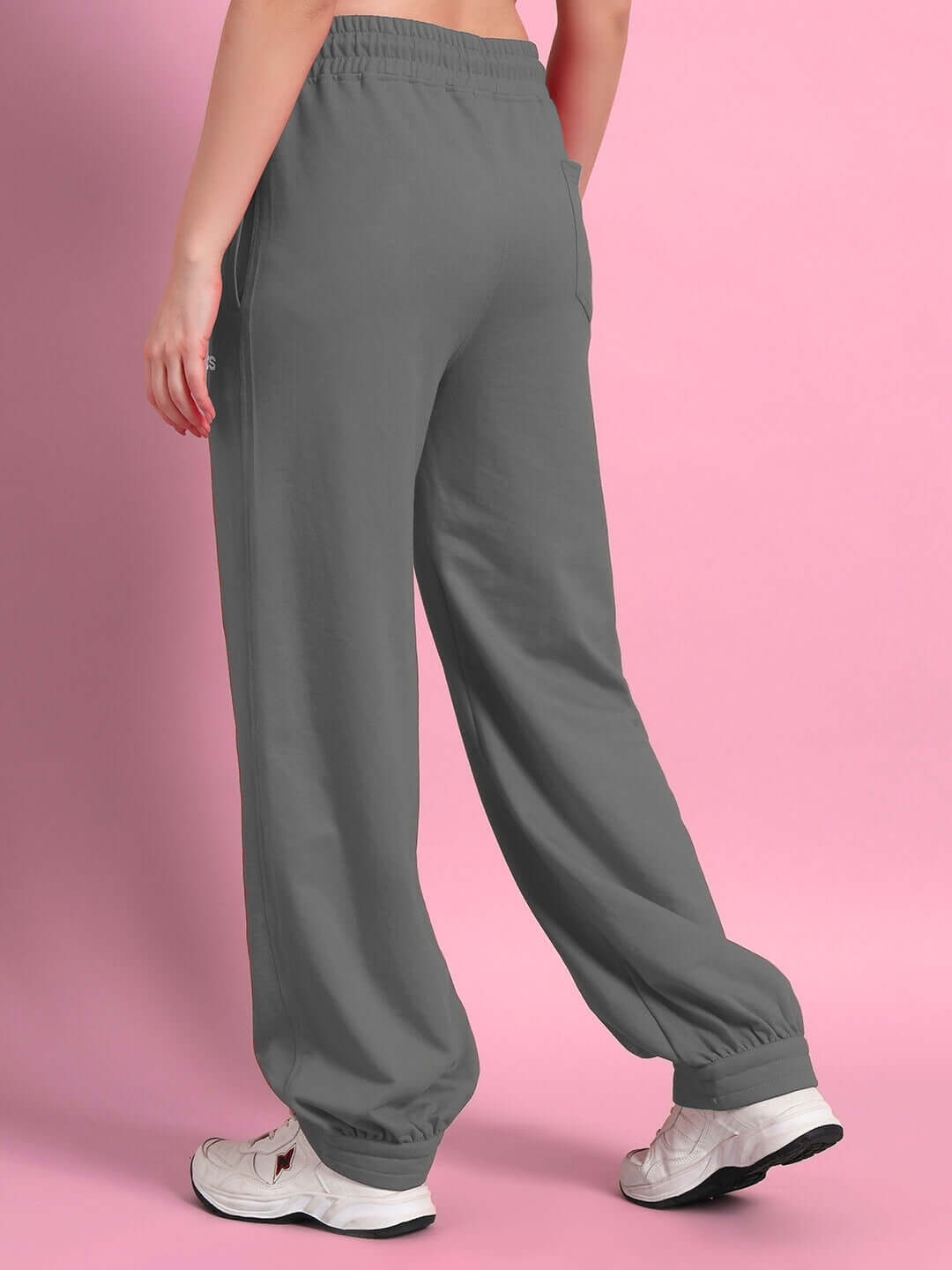 WOMENS AUSTRIAN RELAXED-FIT JOGGERS GREY worn by model, showing back view with elastic waistband and pockets, against pink backdrop.