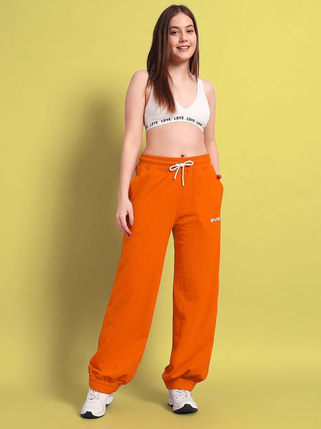 Woman wearing WOMENS AUSTRIAN RELAXED-FIT JOGGERS ORANGE for casual comfort and style.