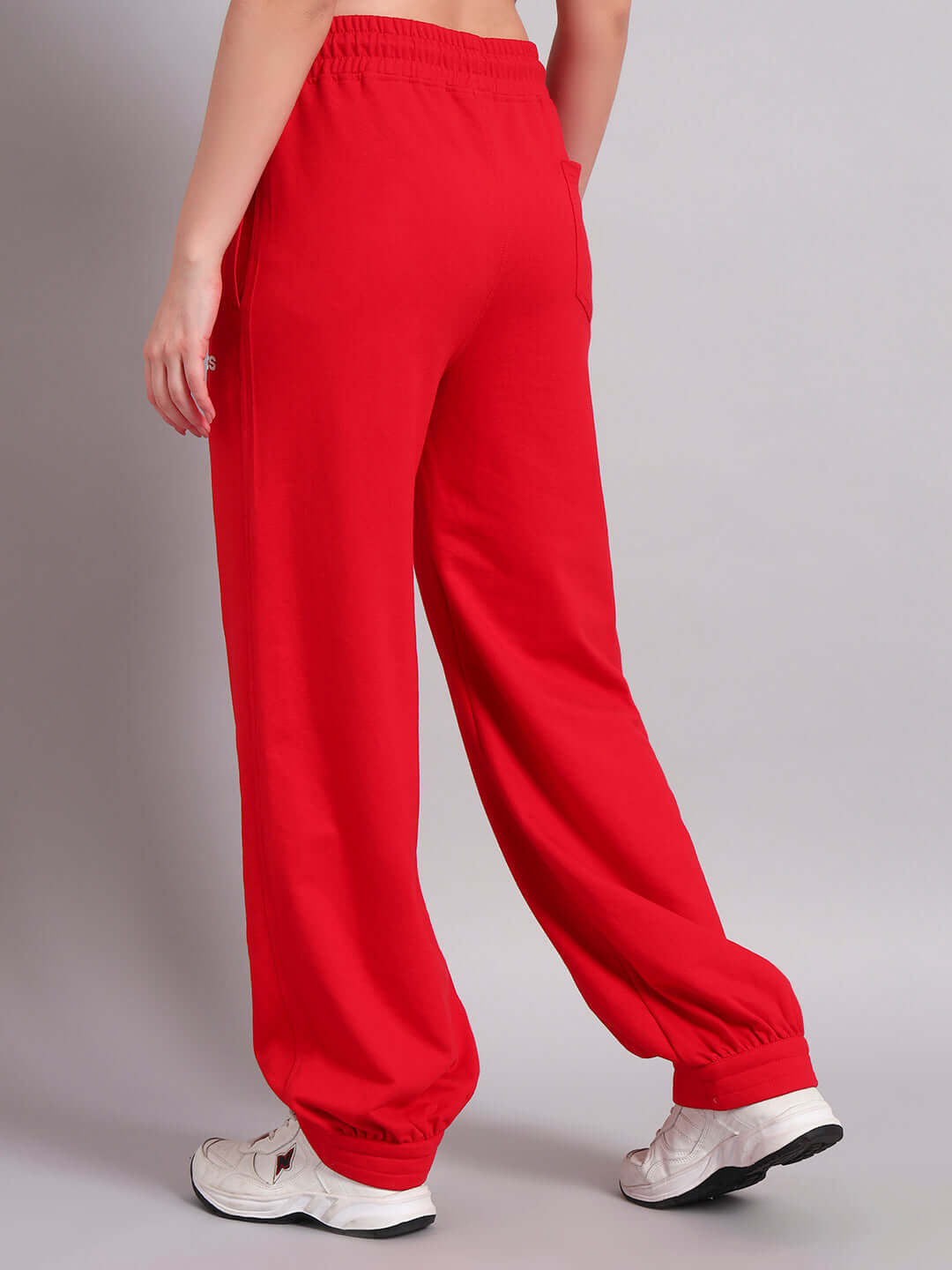 Model wearing WOMENS AUSTRIAN RELAXED-FIT JOGGERS RED, showcasing elastic waistband and sporty style for casual and athleisure wear.