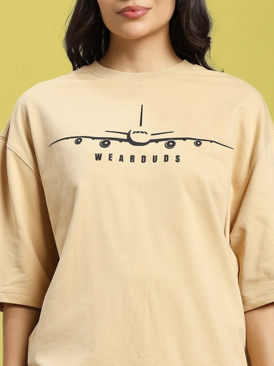 Beige women's oversized aviator designer t-shirt made from premium cotton, featuring front airplane graphic. Bio-washed, 240 GSM.