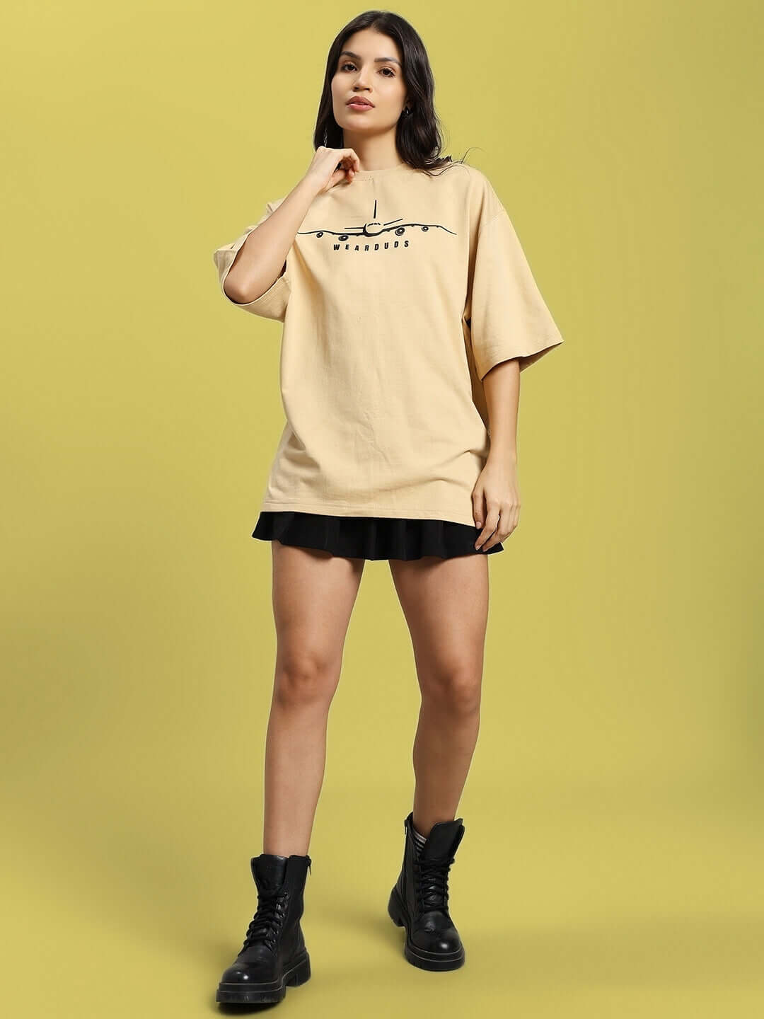 Women's oversized beige aviator designer t-shirt, premium cotton fabric, styled with black boots, made in India by Color By Colours.