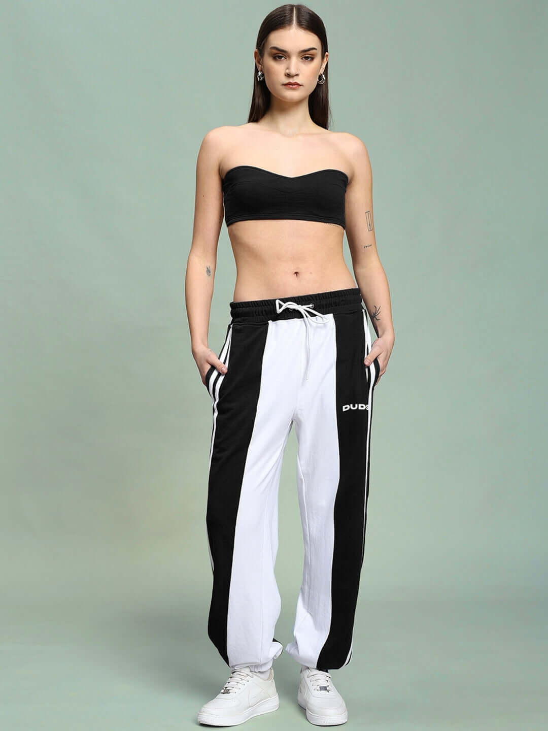 Model wearing WOMEN'S AZORA CO-ORD SET BLACK WHITE, featuring a stylish monochrome design with a bandeau top and track pants.