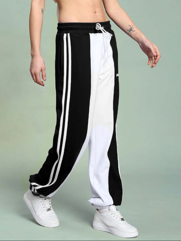 WOMEN'S BALMY RELAXED FIT JOGGER WHITE BLACK, side view showcasing relaxed fit and sporty stripes.