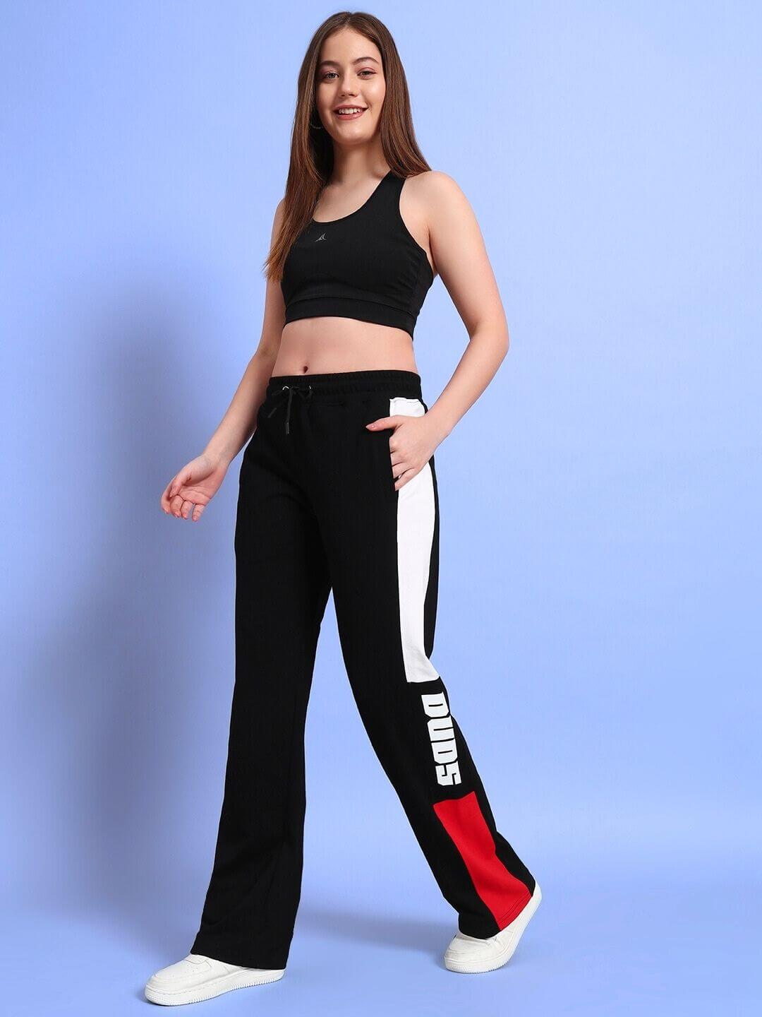 Woman wearing Women's Belgians Relaxed-Fit Joggers in Black Red, stylish and comfortable sportswear by DUDS.