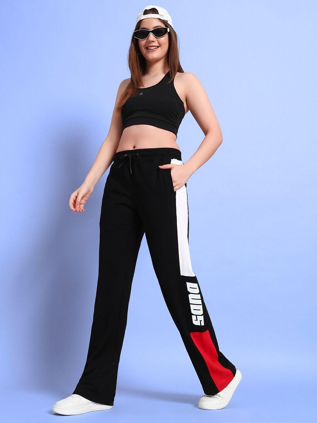 Woman wearing black red relaxed-fit joggers by DUDS, showcasing sporty style. Perfect for casual wear and customizable fit options.