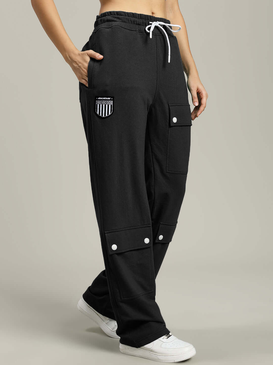 Model wearing Women's Black Flap Pocket Baggy Jogger by DUDS, featuring customizable fit options and crafted by experienced tailors.