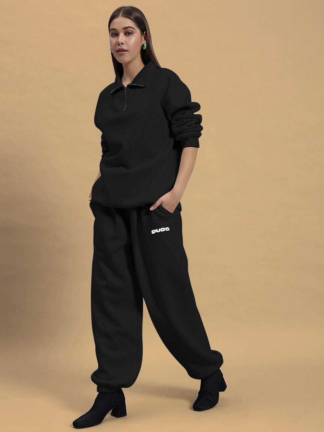 Model wearing Women's Bona-Fide Fleece Co-Ord in black by DUDS, showcasing matching top and pants for stylish comfort.