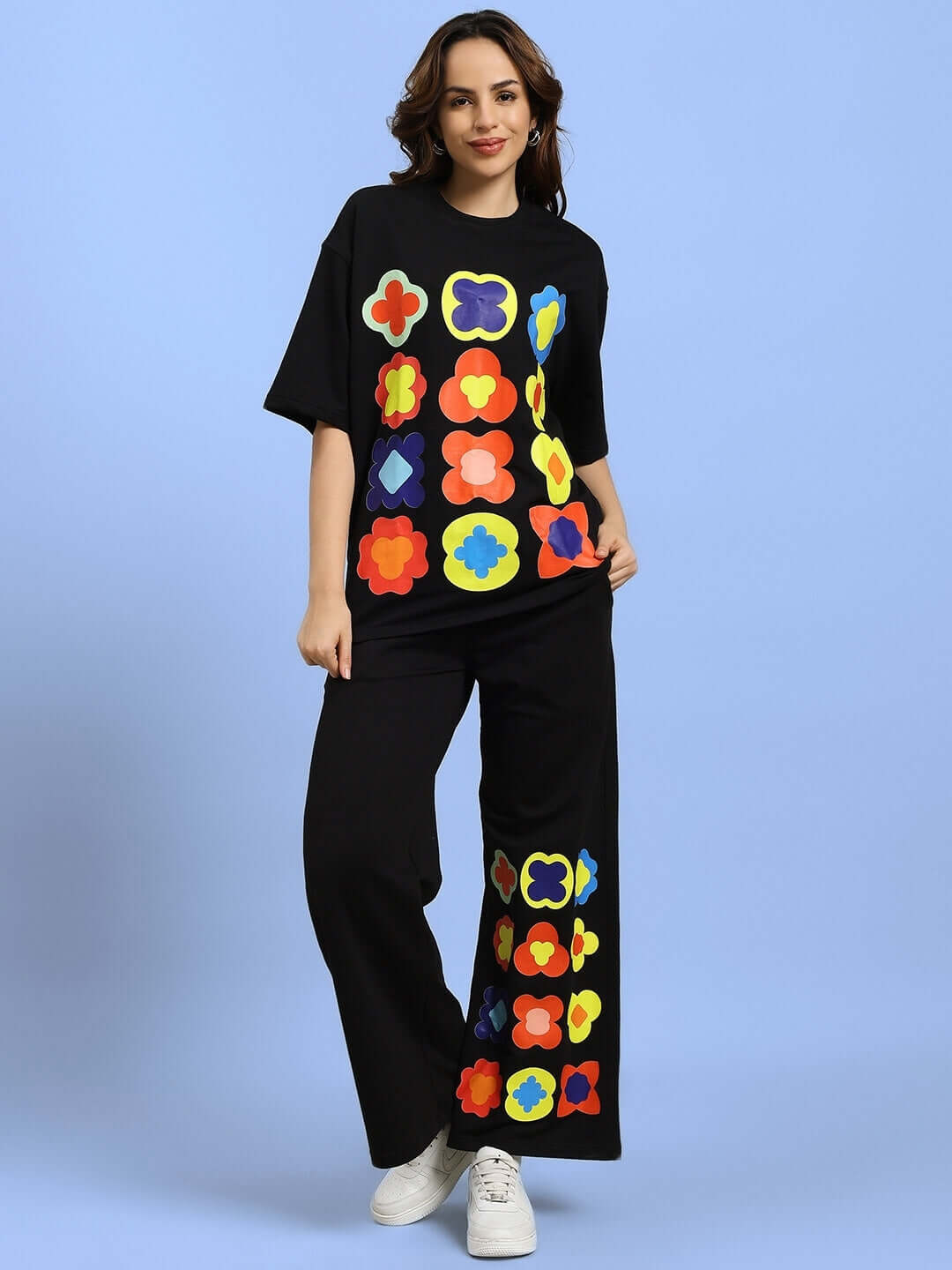 Woman wearing WOMEN'S HOLLISTER CO-ORD SET BLACK with colorful geometric patterns, showing stylish and casual streetwear.