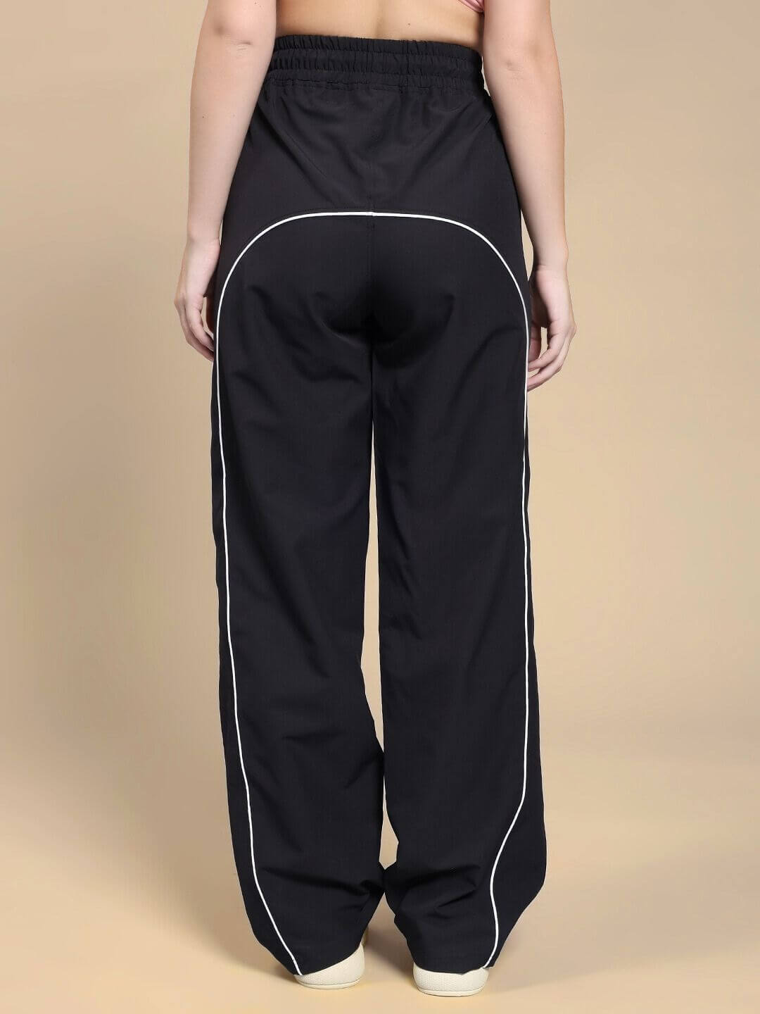 Back view of WOMEN TURBO TRACK RELAXED-FIT JOGGERS BLACK highlighting comfortable and stylish design for active women.