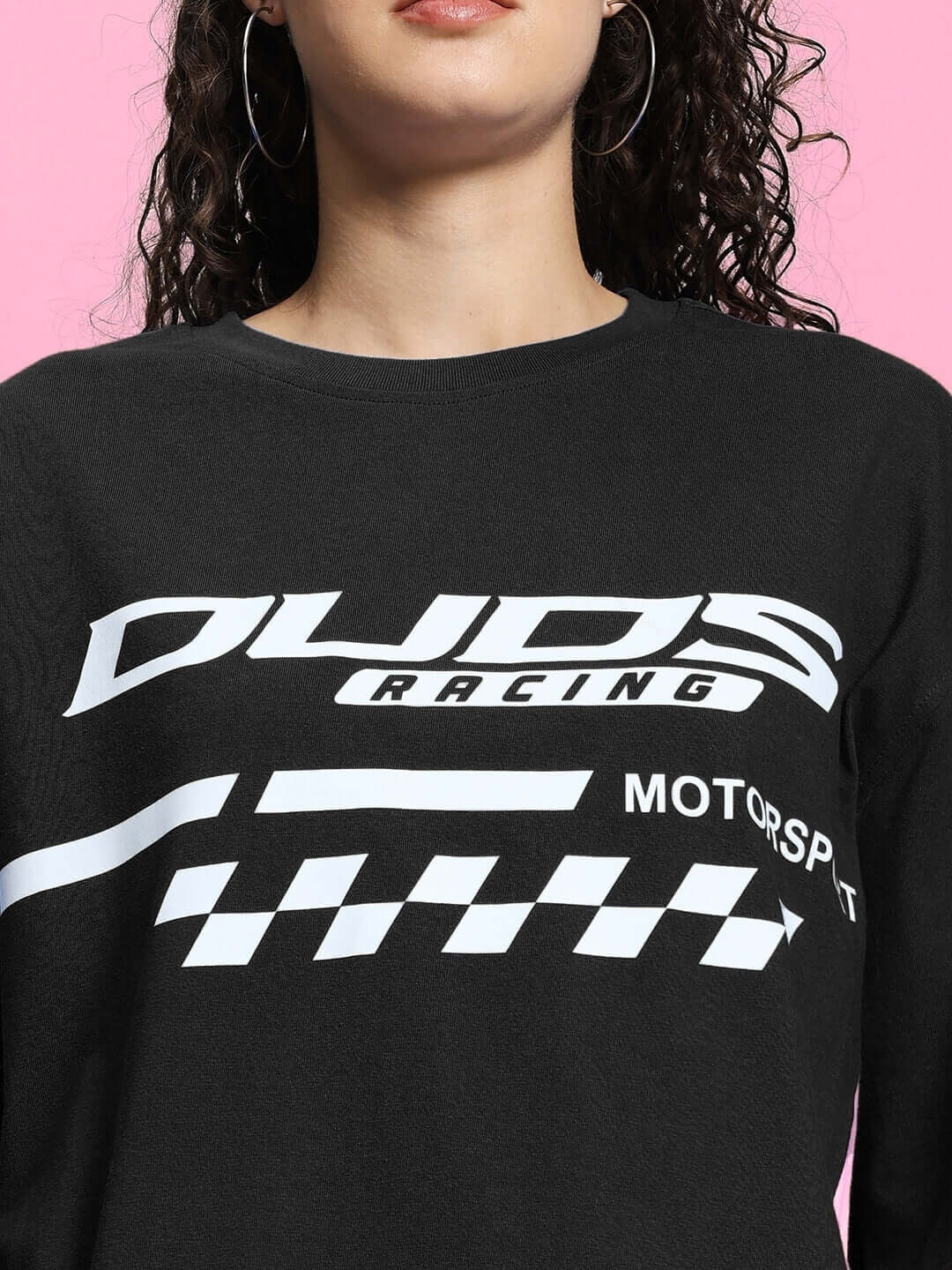 Woman wearing WOMEN'S INDY OVER-SIZED CLASSIC T-SHIRT BLACK with racing logo.