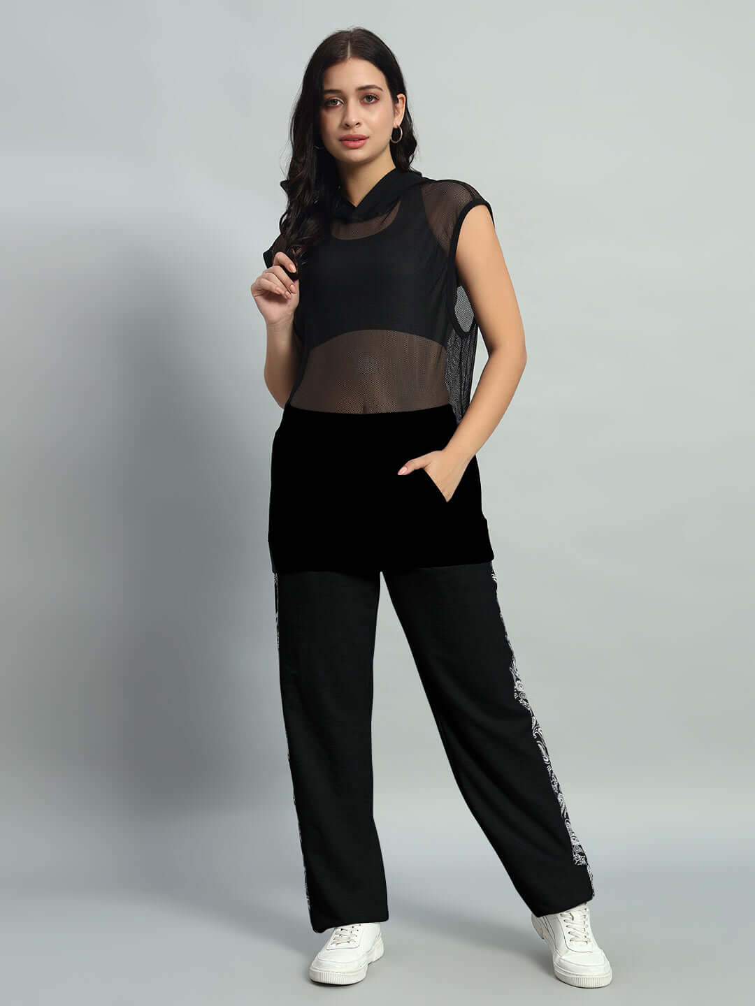 Woman wearing WOMEN'S BOOGIE OVERSIZED CO-ORD SET BLACK with mesh top and sporty trousers, casual chic fashion style.