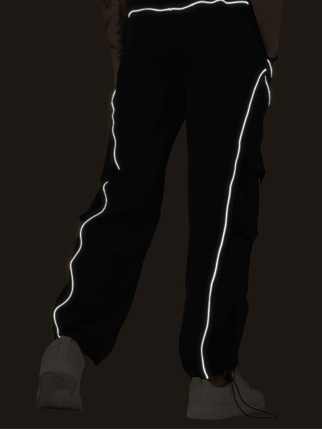 Women's black parachute cargo pants with reflective stripes