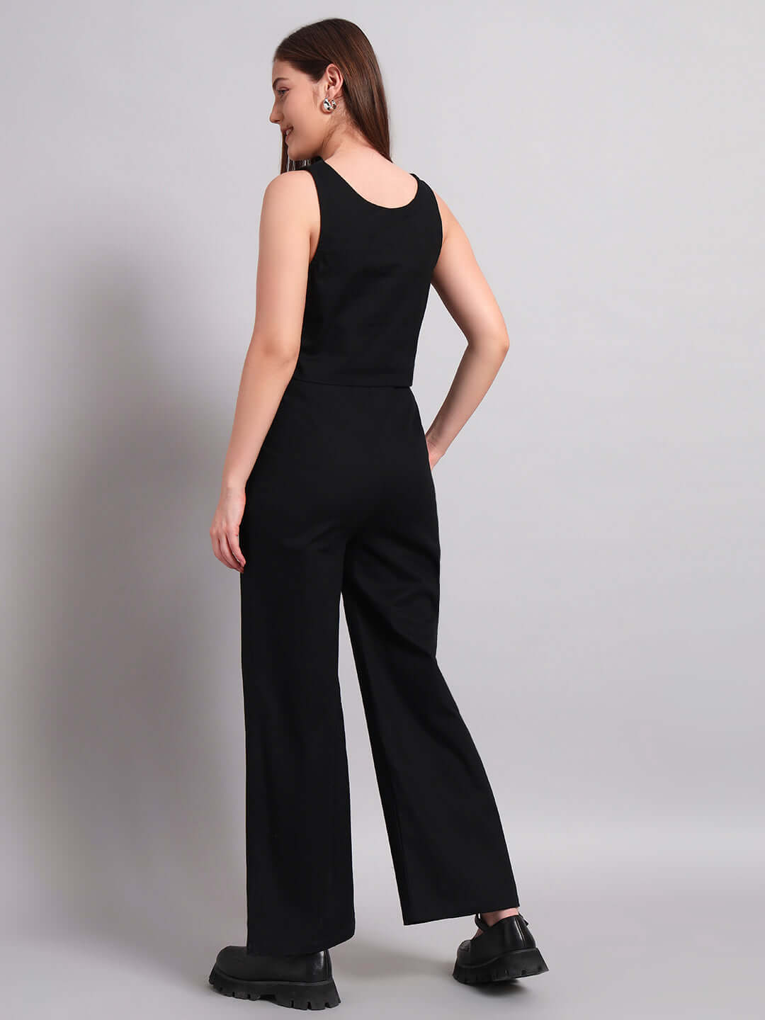 Back view of a woman wearing a black Women's Chic Relaxed Fit Jogger, showcasing its sleek design and comfortable fabric.