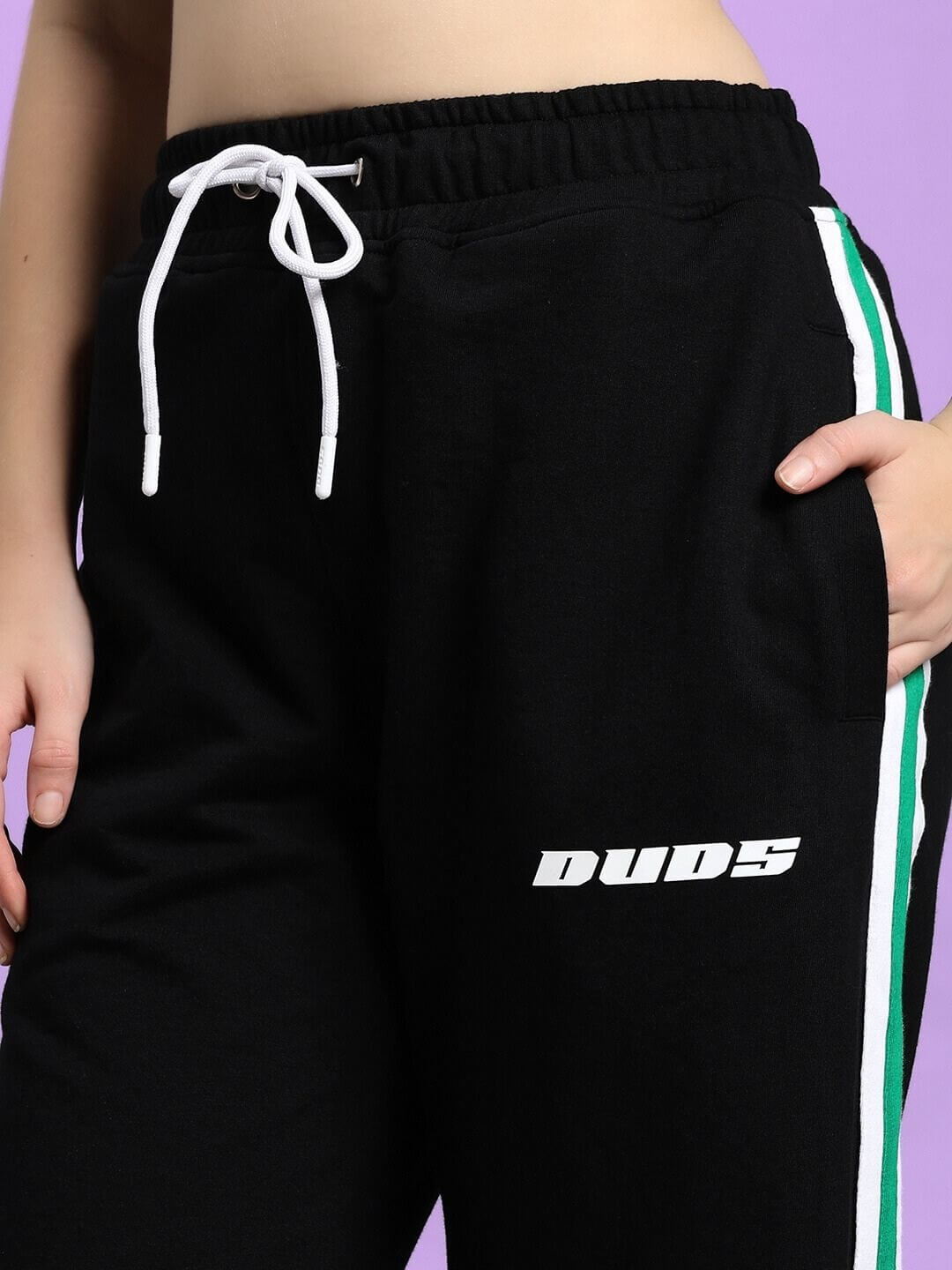 Close-up of WOMEN'S VELO GREEN STRIPE RELAXED FIT JOGGER BLACK with side stripe detail.