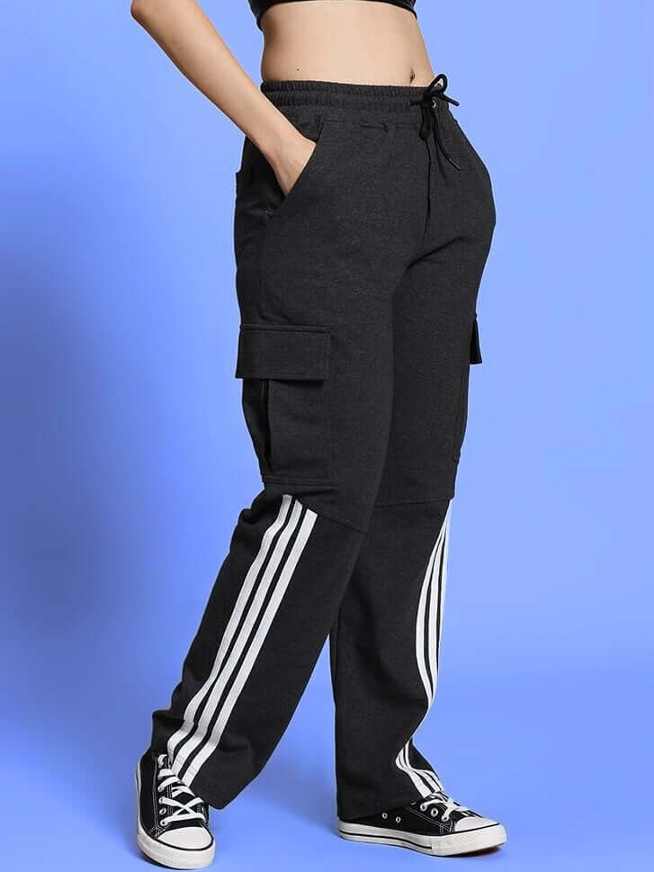 Model wearing Women's REDROIT 5 Pocket Relaxed Fit Joggers in Black, featuring side stripes and cargo pockets, styled with sneakers.