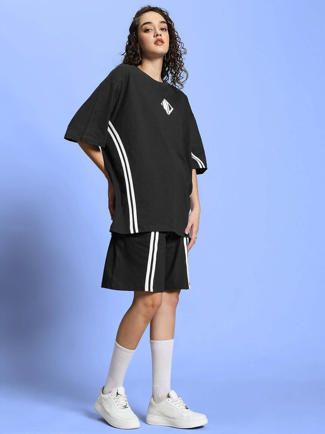 Model wearing WOMEN'S OUTLOOK SUMMER CO-ORD SHORTS SET BLACK, featuring a relaxed-fit t-shirt and matching shorts, perfect for summer.