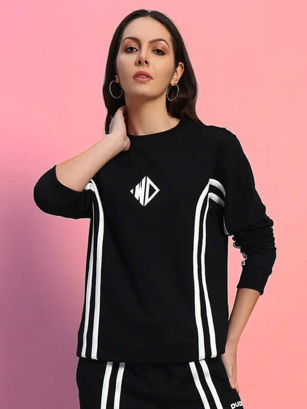 Woman wearing WOMEN'S OUTLOOK SWEATSHIRT BLACK WITH WHITE STRIPE against pastel background.