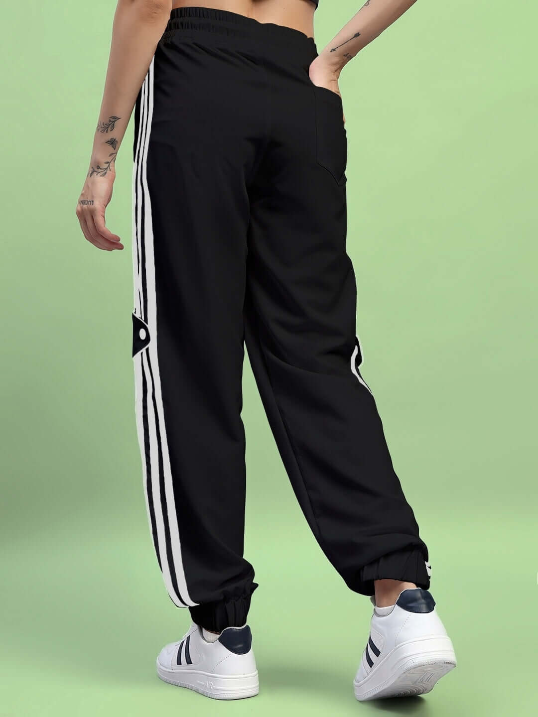 Back view of Womens Bolson Stripes Relaxed-Fit Joggers Black showcasing sporty design with stripes and comfortable fit.