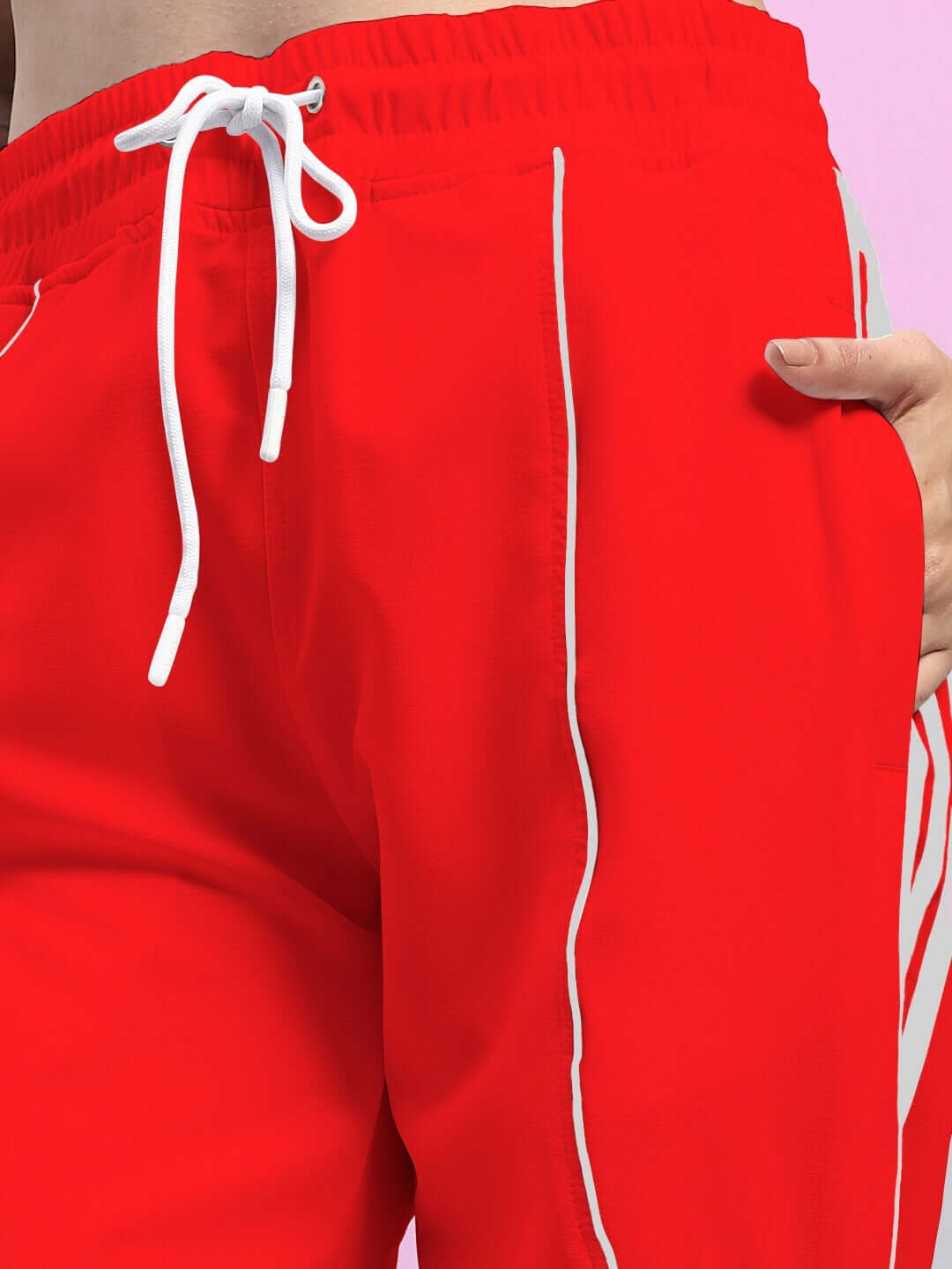 Close-up of women's red relaxed-fit joggers with white stripes and drawstring from Bolson collection.