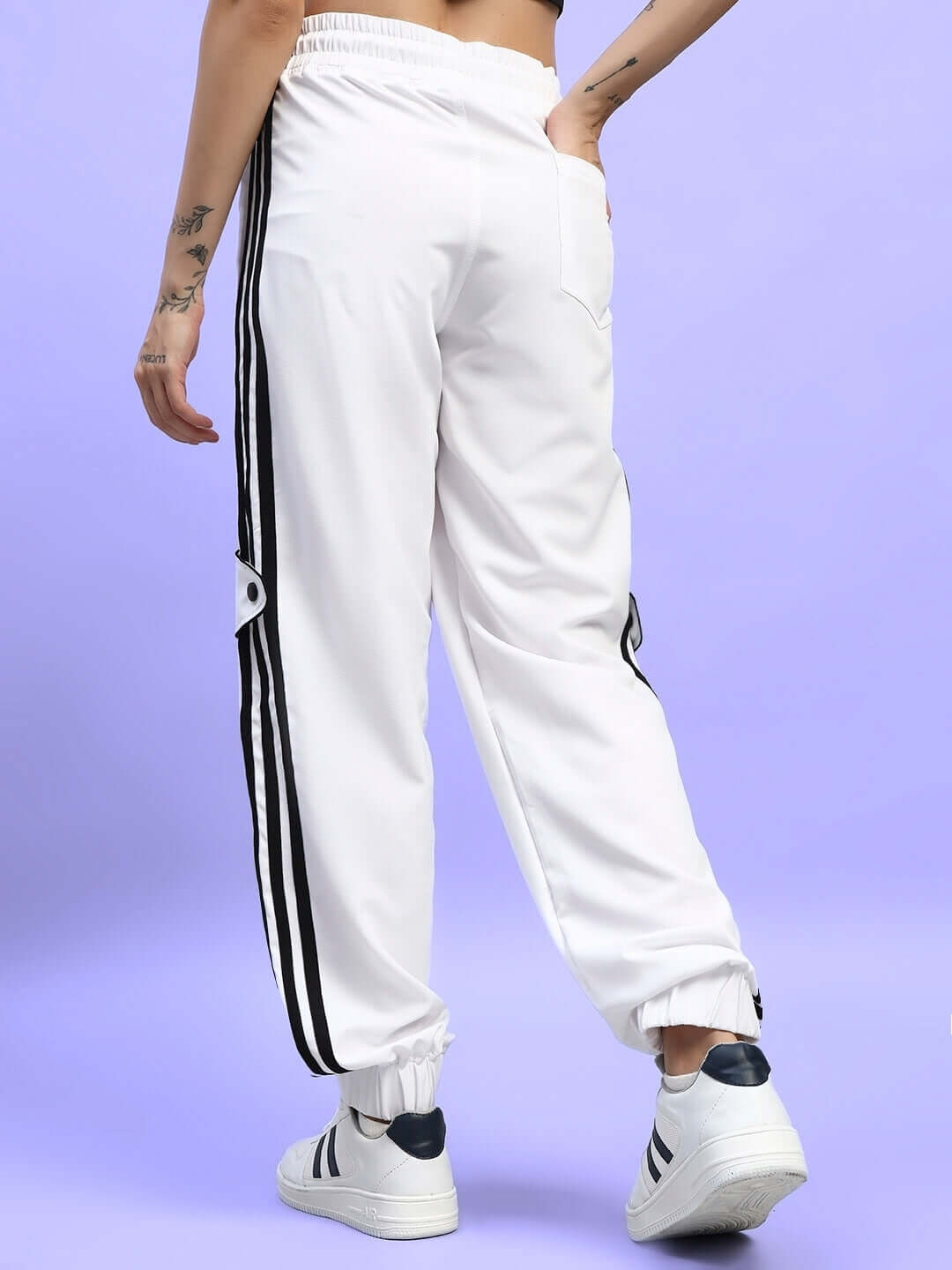 Back view of WOMEN'S BOLSON STRIPES RELAXED-FIT JOGGERS WHITE with black stripes on a purple background.