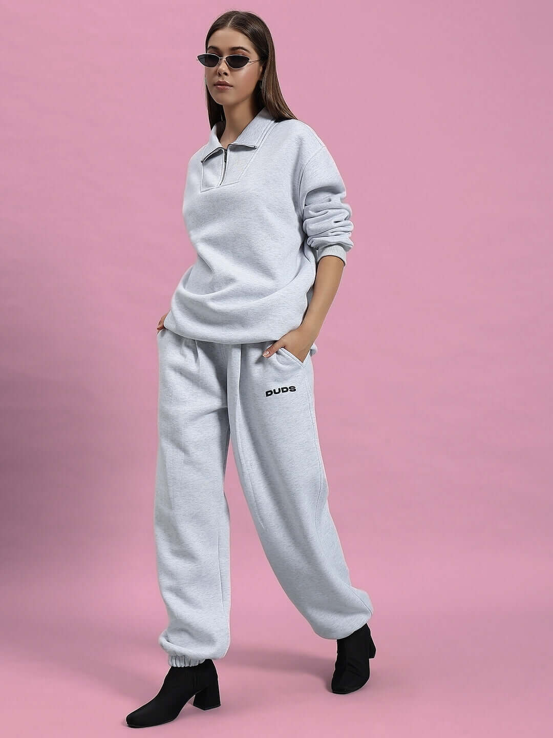 Model wearing WOMEN BONAFIDE FLEECE CO-ORD MELANGE GREY outfit with ribbed cuffs and relaxed fit on pink background.