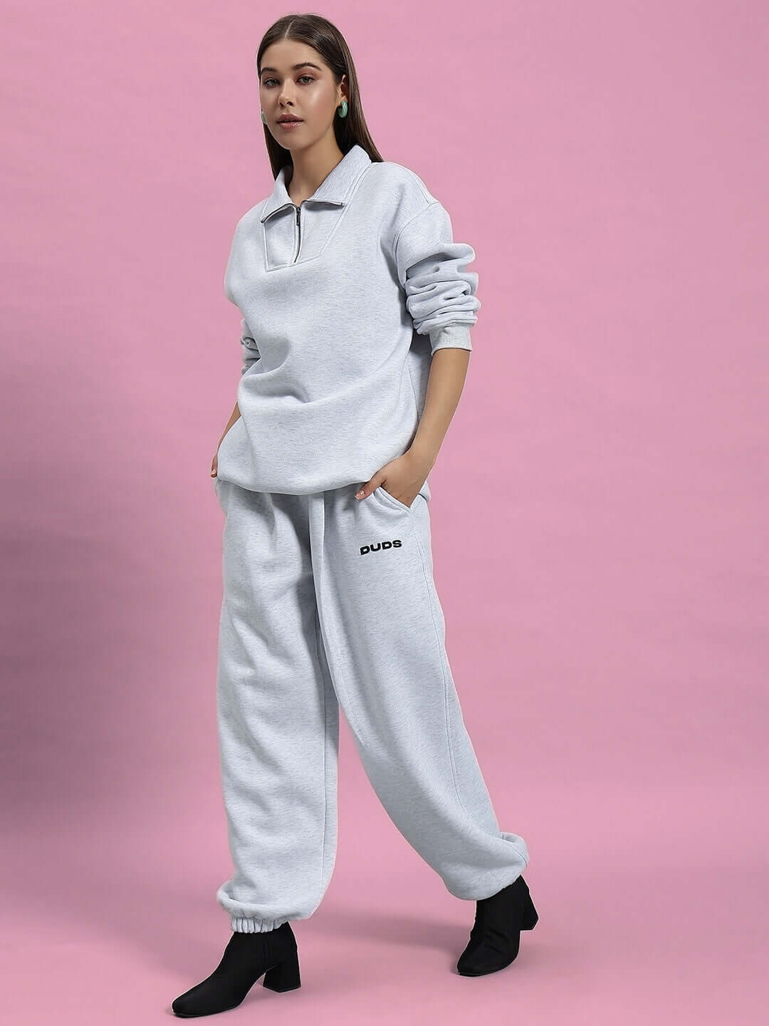 Woman wearing Women Bonafide Fleece Co-ord Melange Grey set, featuring cozy, stylish fleece top and bottoms for casual outings.