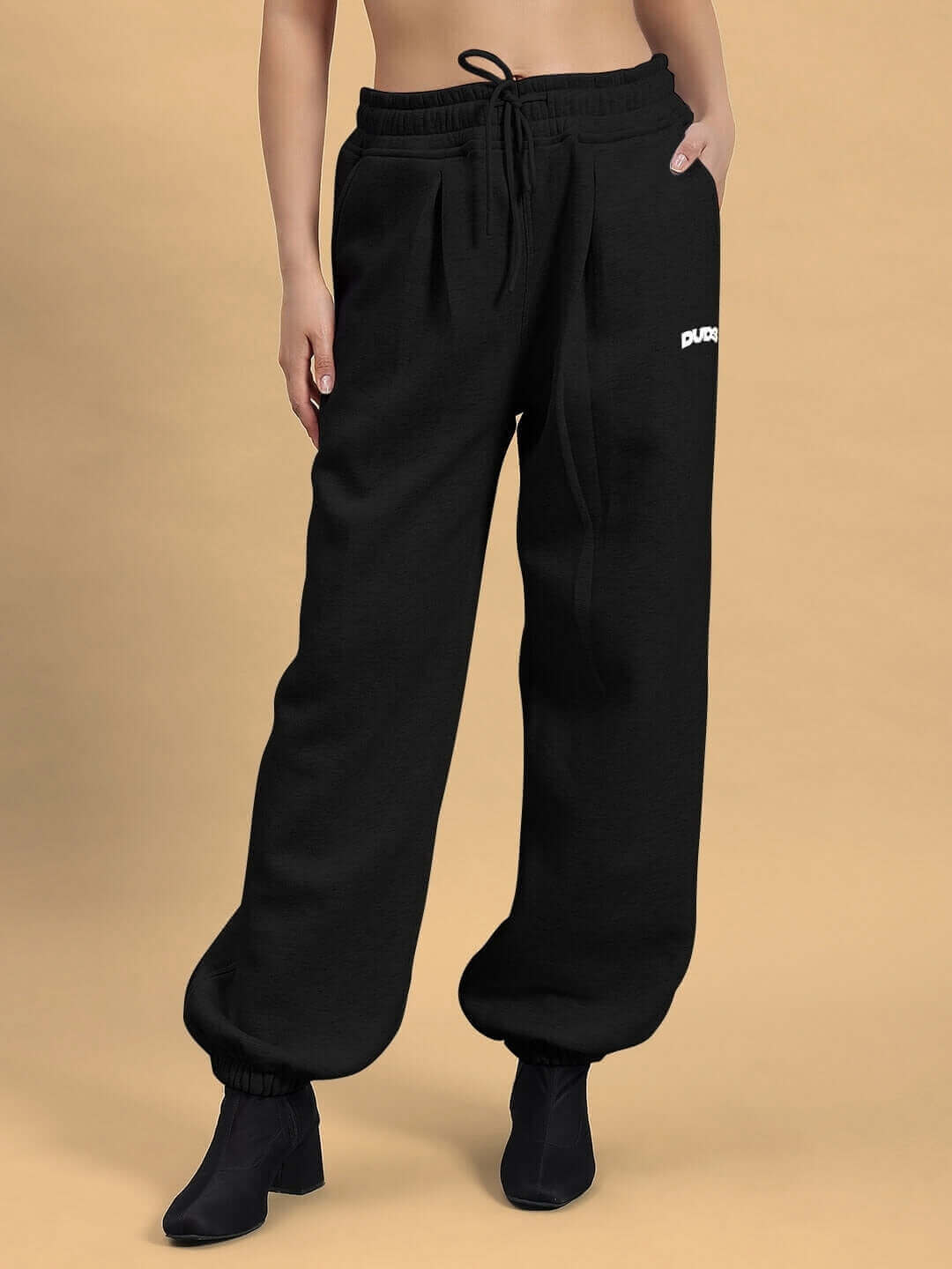 Woman wearing black fleece co-ord pants from DUDS, showcasing a comfortable and stylish fit.