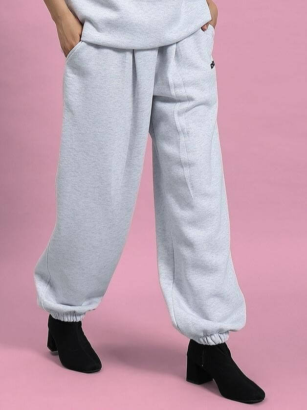 Women's Bona-Fide Fleece Pant in Melange Grey, featuring a stylish and comfortable design ideal for casual wear, shown on a pink background.