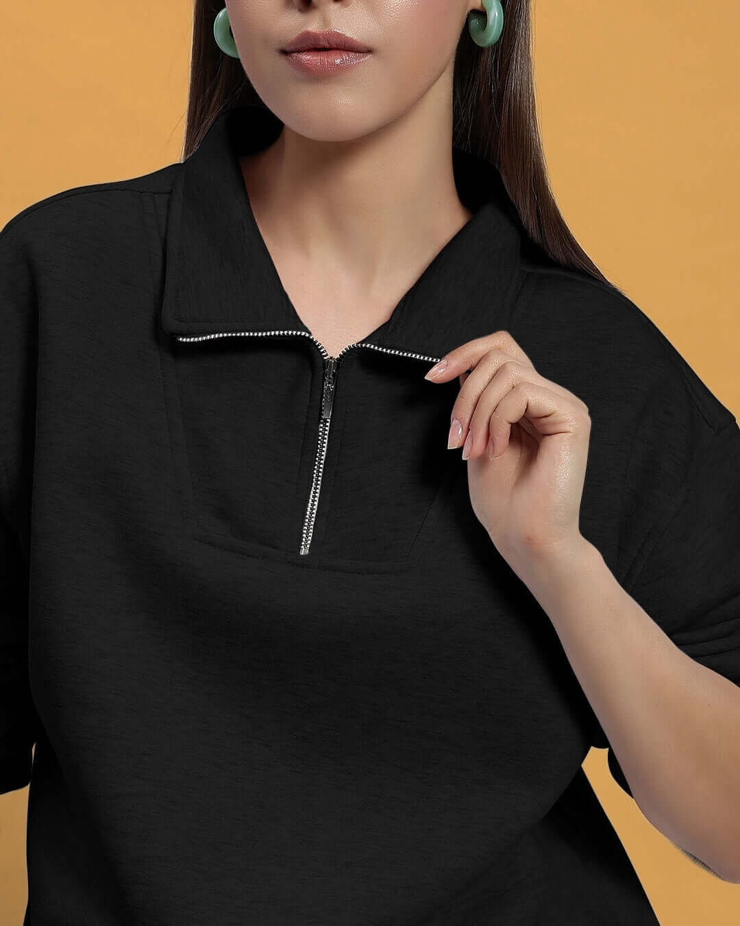 Woman wearing black bona-fide sweatshirt with zip detail, showcasing custom fit options from DUDS.