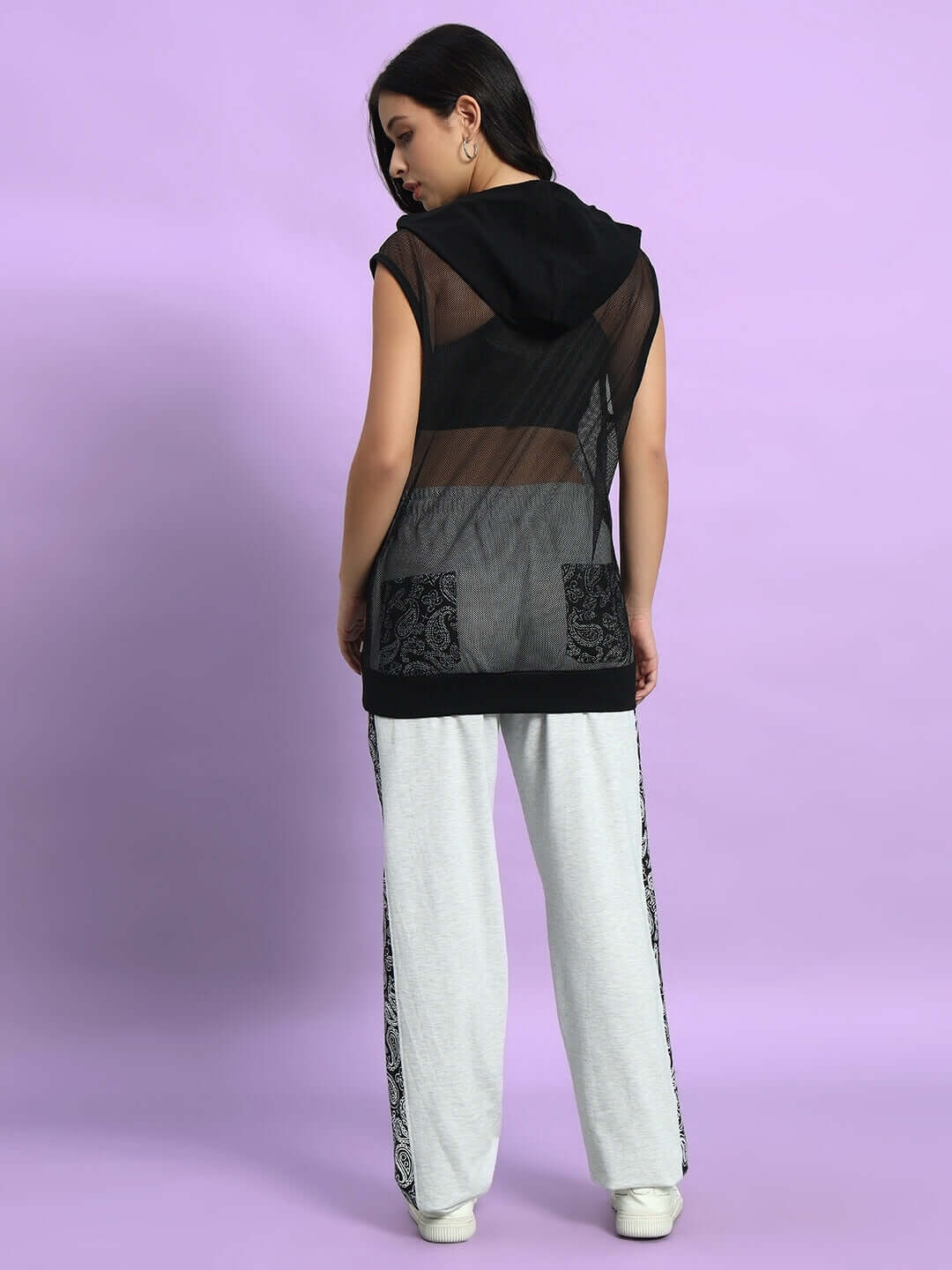 Woman wearing Women's Boogie Oversized Co-Ord Set in melange grey with black mesh top, against a lavender background.