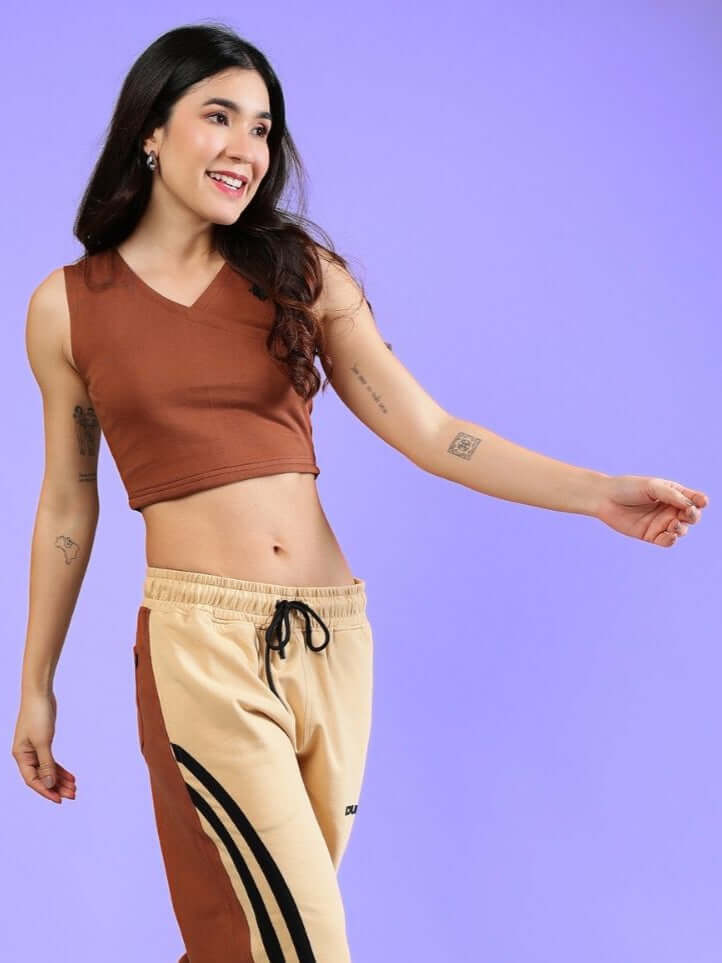Model wearing Women's Bracing Crop Top in brown, made of premium cotton and elastane fabric, styled with active joggers.