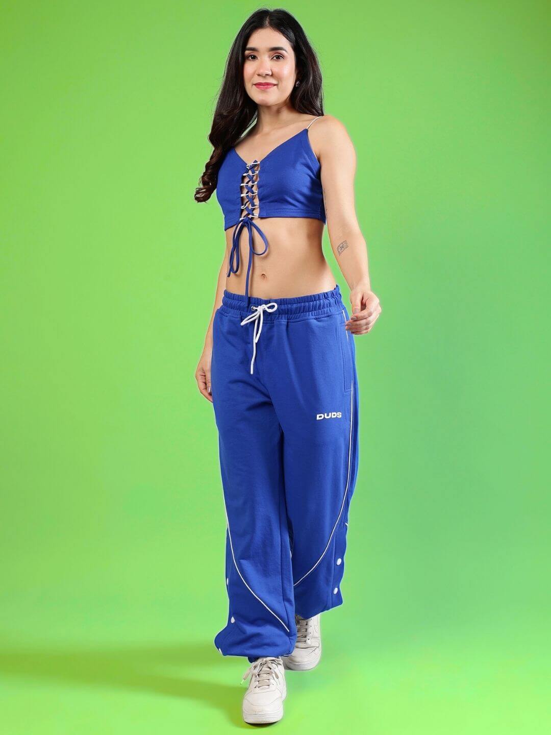 Woman wearing the WOMEN'S BROSSFINE CO-ORD SET in royal blue, featuring a premium cotton blend, stylish lace-up top, and comfortable pants.