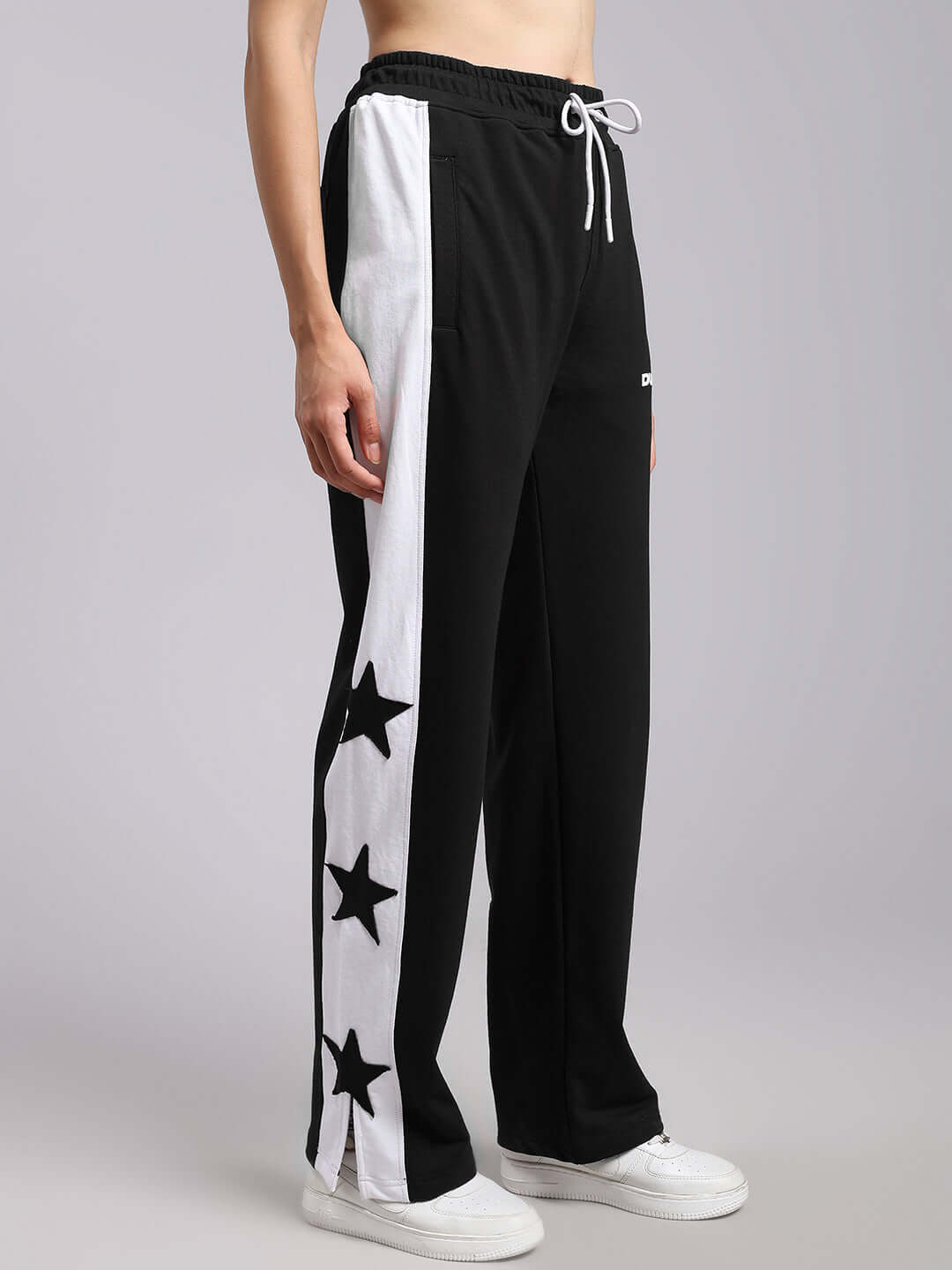 Model wearing WOMENS BROX STAR RELAXED FIT JOGGERS BLACK-WHITE with star design on side panel.
