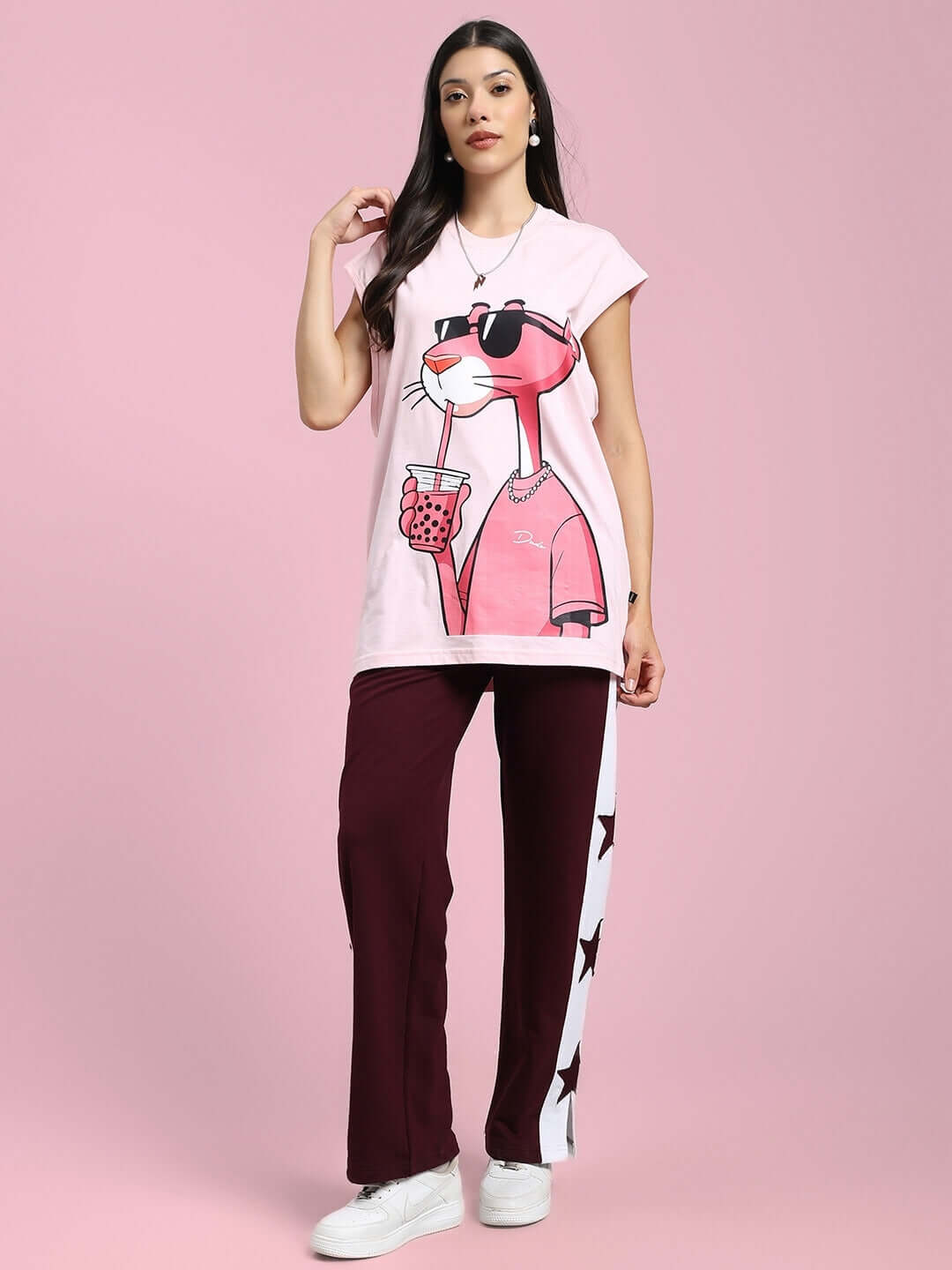 Model wearing maroon-white Brox Star relaxed fit joggers by DUDS with pink graphic t-shirt, showcasing casual chic fashion.