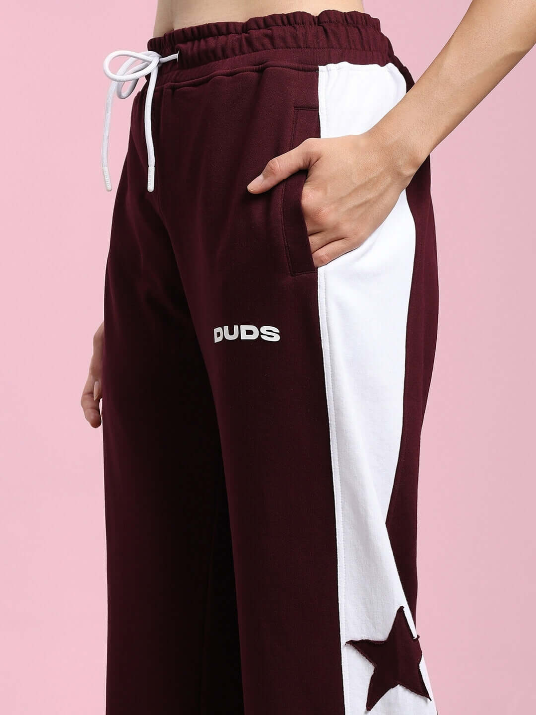 Women's maroon-white relaxed fit joggers with white stripes and star detailing, "DUDS" logo visible.