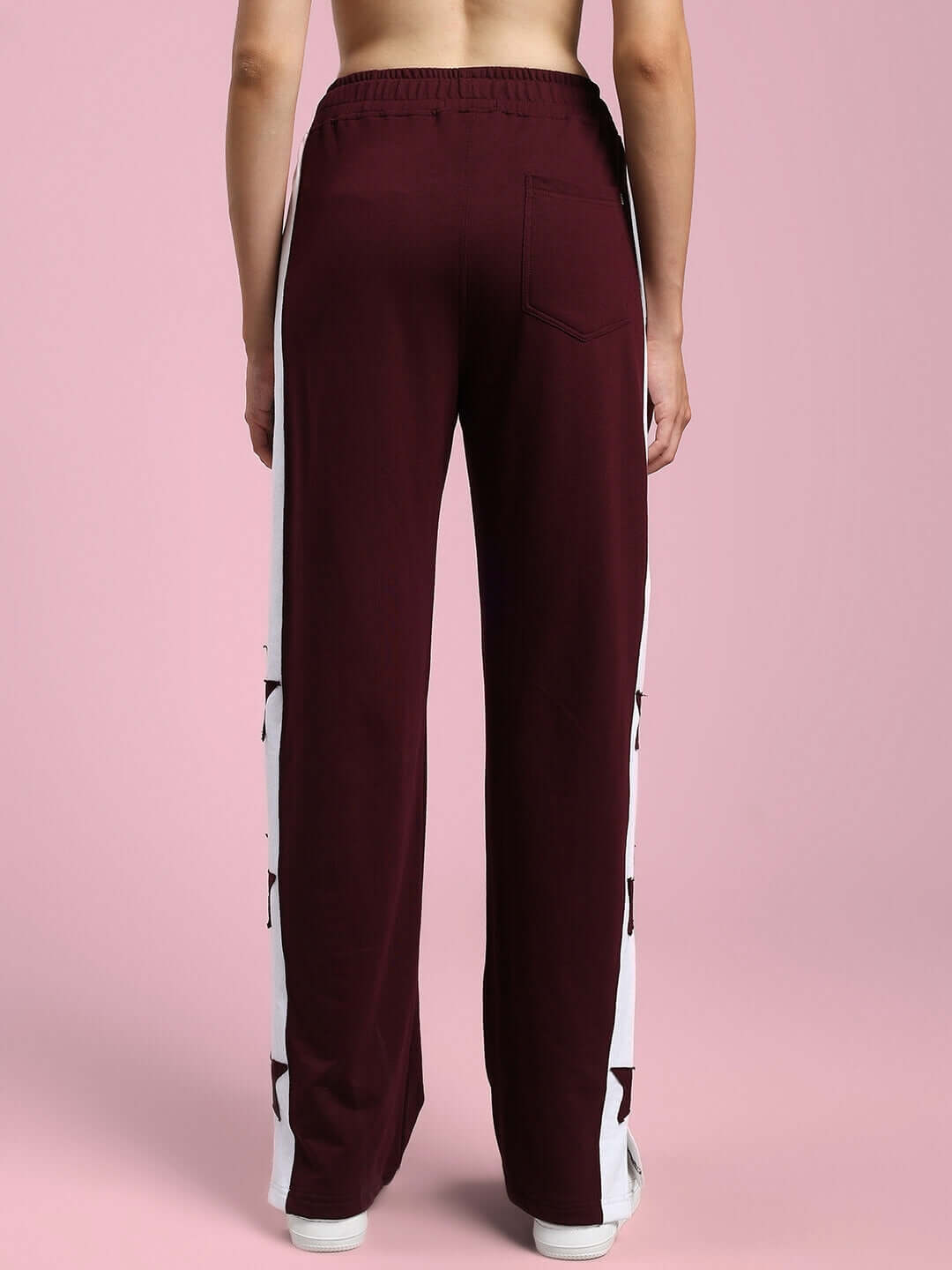 Back view of women's maroon-white relaxed fit joggers with star pattern, featuring a comfortable elastic waistband and stylish design.