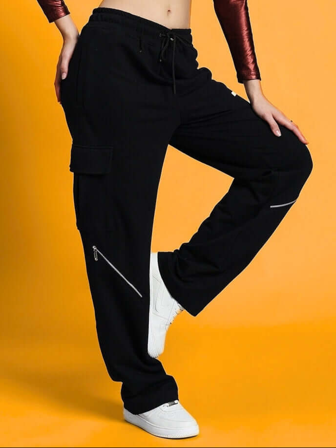 Model wearing Women's Bruno 5 Pocket Cargo Pant Black, showcasing stylish and functional design on a vibrant background.